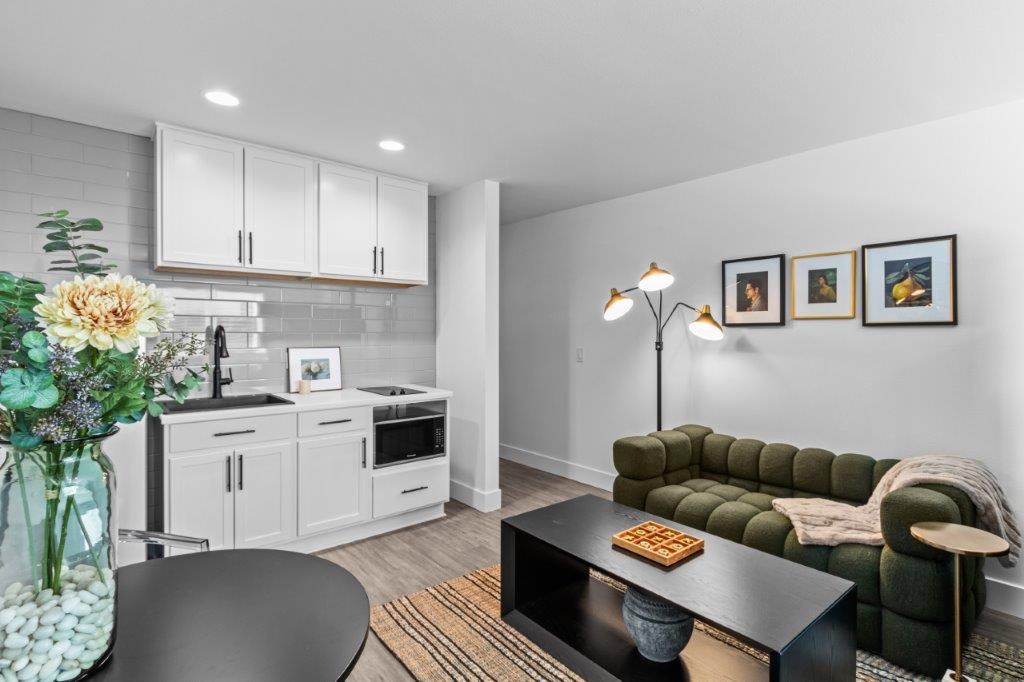 a living room with a kitchen and a table
